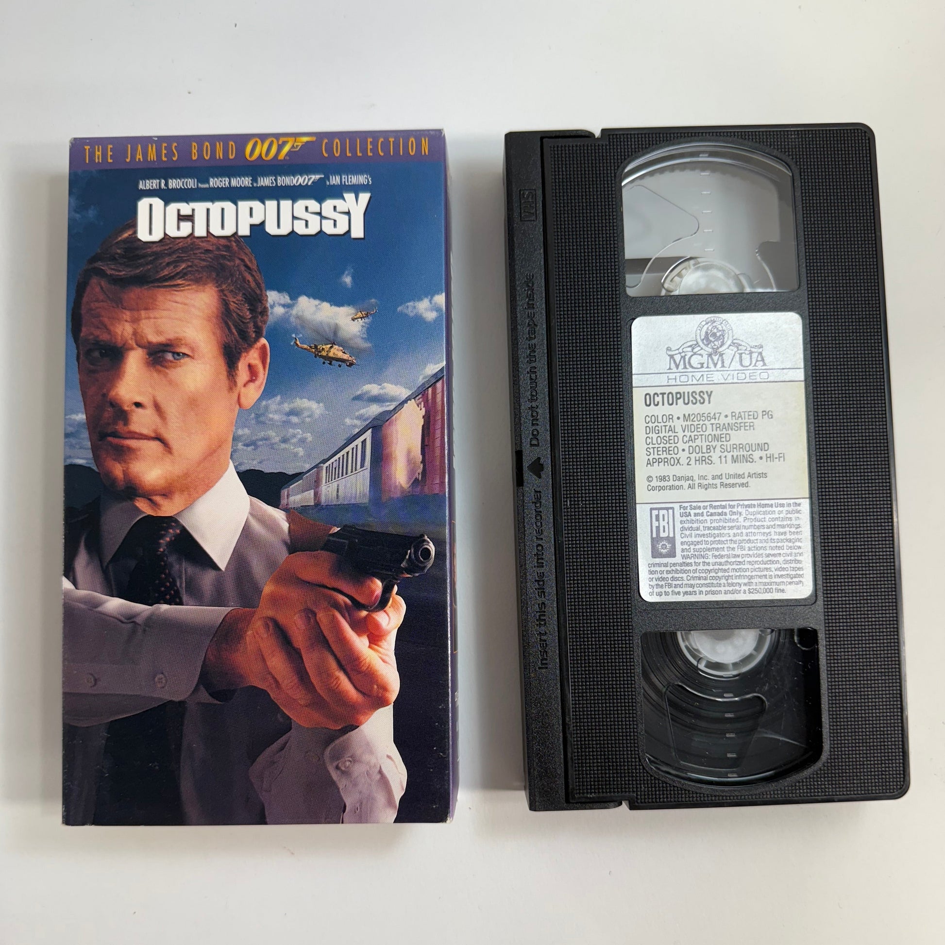 VHS tape and cover of 'Octopussy' James Bond movie on a white background